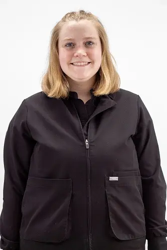 Gillian S., dental team member at Peachtree City practice, smiling in professional portrait.