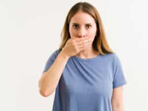 A girl showing she is having bad breathe