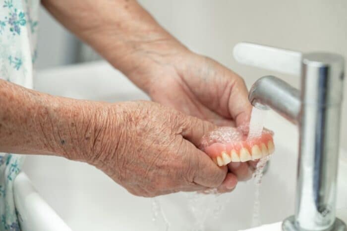 how to clean dentures properly peachtree dentist explains