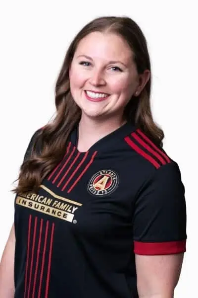 Dr. Christine K smiles in her American Family Insurance dental team uniform at Peachtree City practice.