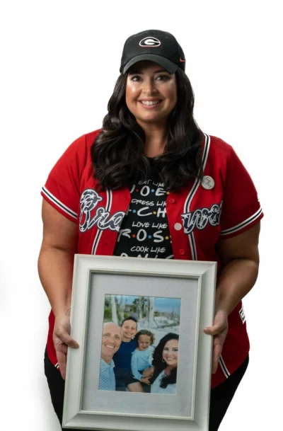 Kellie Willis, dental team member at Peachtree City practice, holding family photo.