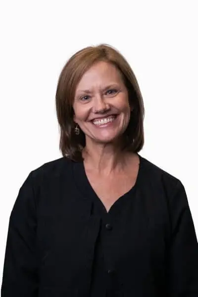 Kristi W, dental team member at Peachtree City practice, smiling in professional portrait.