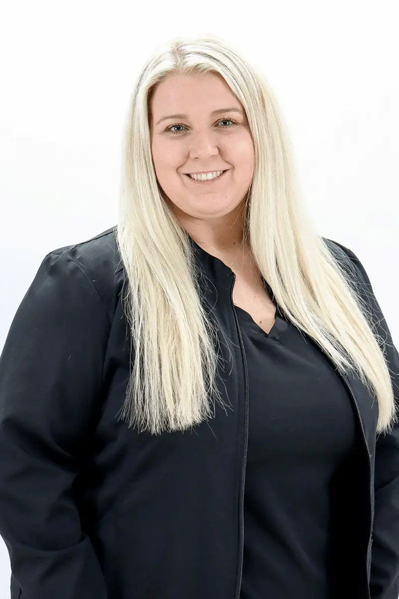 Sumer J, dental professional at Peachtree City dental practice, smiling at camera.