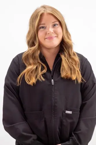 Kelsey S, dental team member at Peachtree City practice, wearing black dental uniform.
