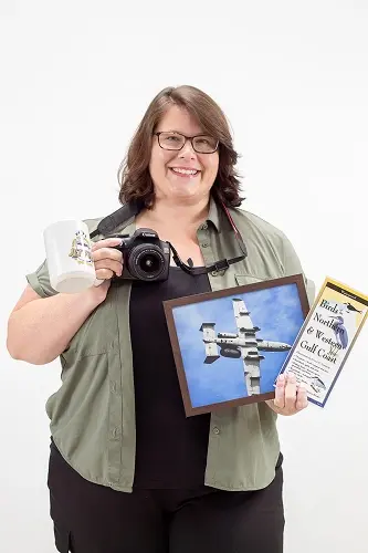 Laurena M holds a camera and displays her photography work featuring dental imagery.
